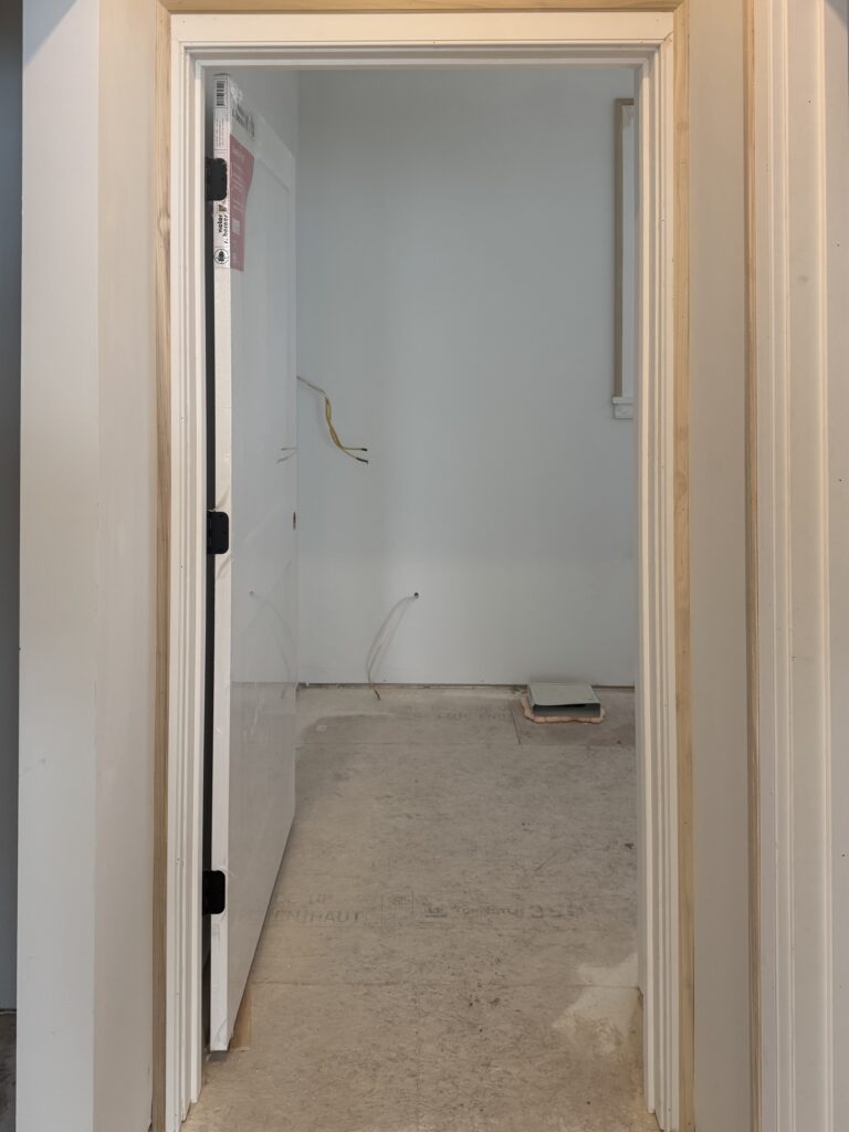 Doorway with trim cut down due to limited wall space around the opening